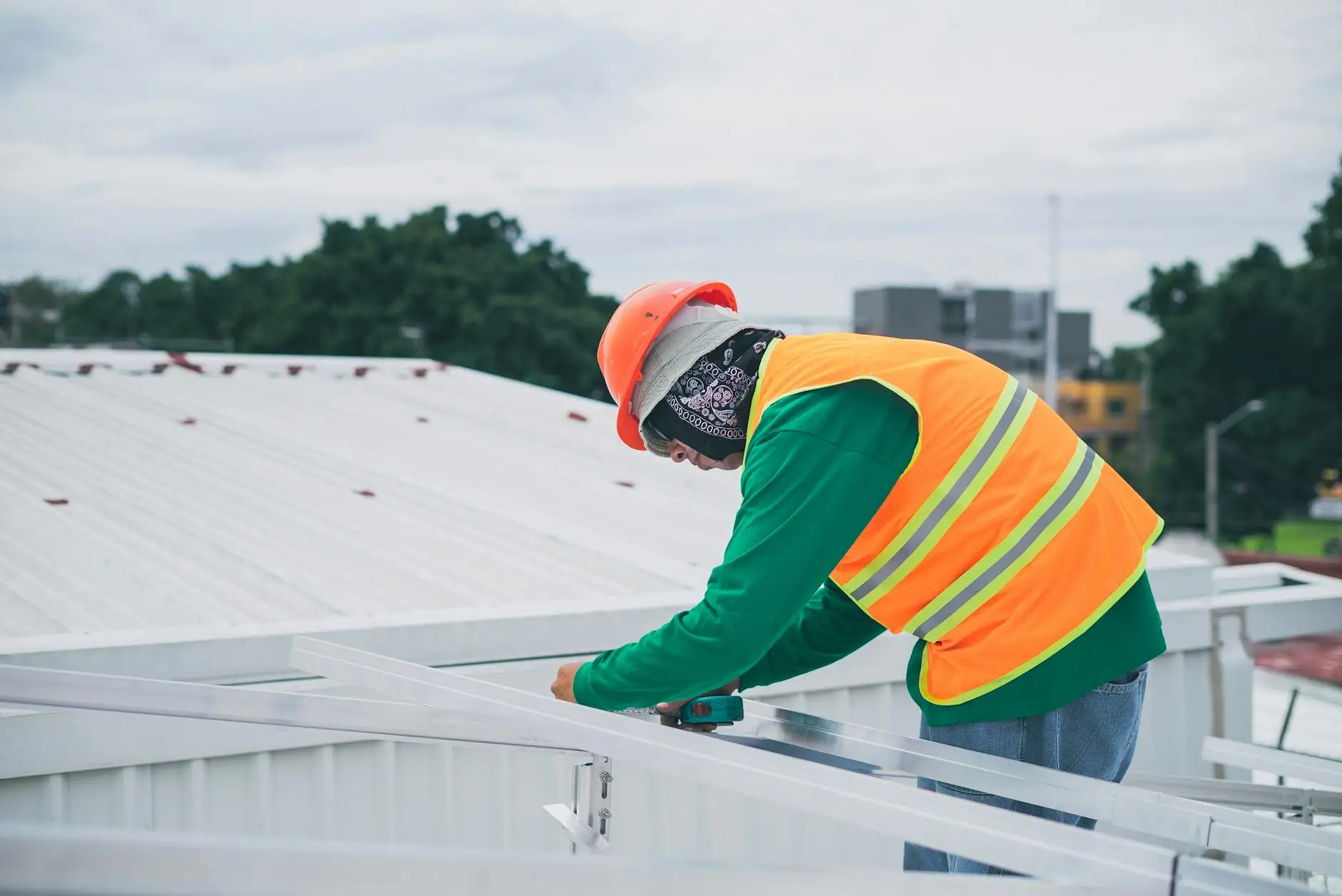 A close-up of a professional roofer installing high-quality underlayment on a Sandy roof, ensuring leak protection.